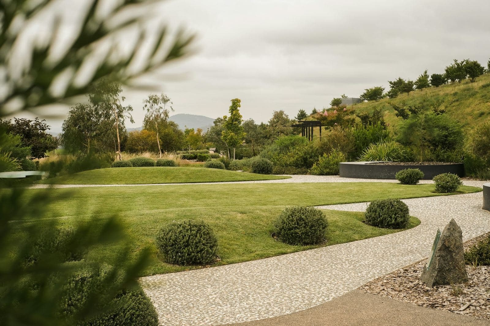 Landscaped grounds with gravel path and shaped shrubs
