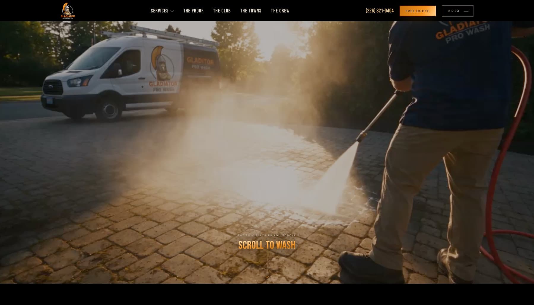 Gladiator Pro Wash concept — the opening frame of the scroll film, a crew member pressure-washing pavers at golden hour